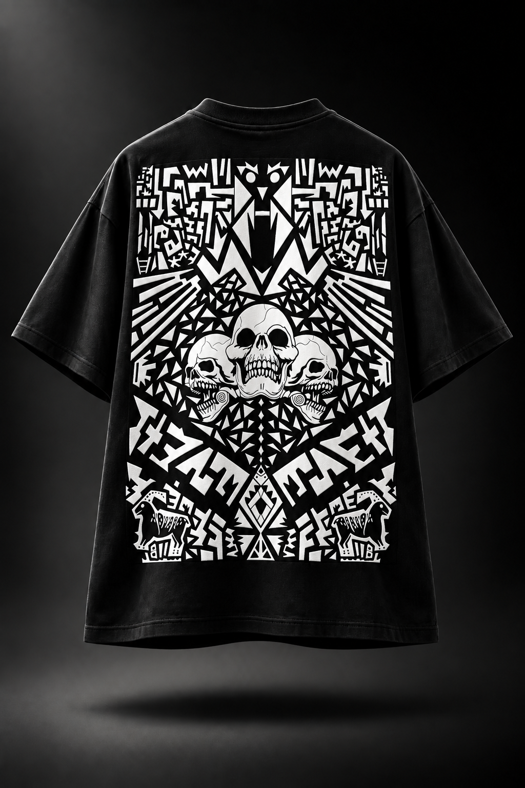 A black oversized LMNO t-shirt with a large white graphic print on the back, featuring a central skull surrounded by intricate geometric and tribal patterns.