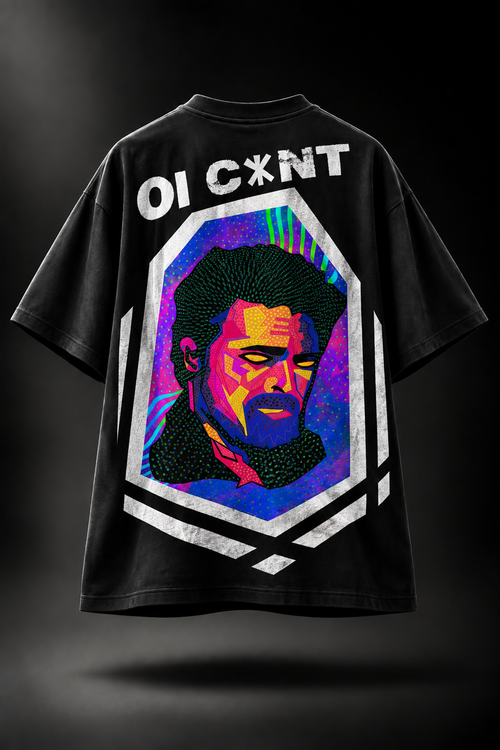 A black oversized LMNO t-shirt featuring a colorful pop-art portrait of a man with the text 'OI C*XNT' printed above it. The graphic is set within a white geometric border on a dark background.