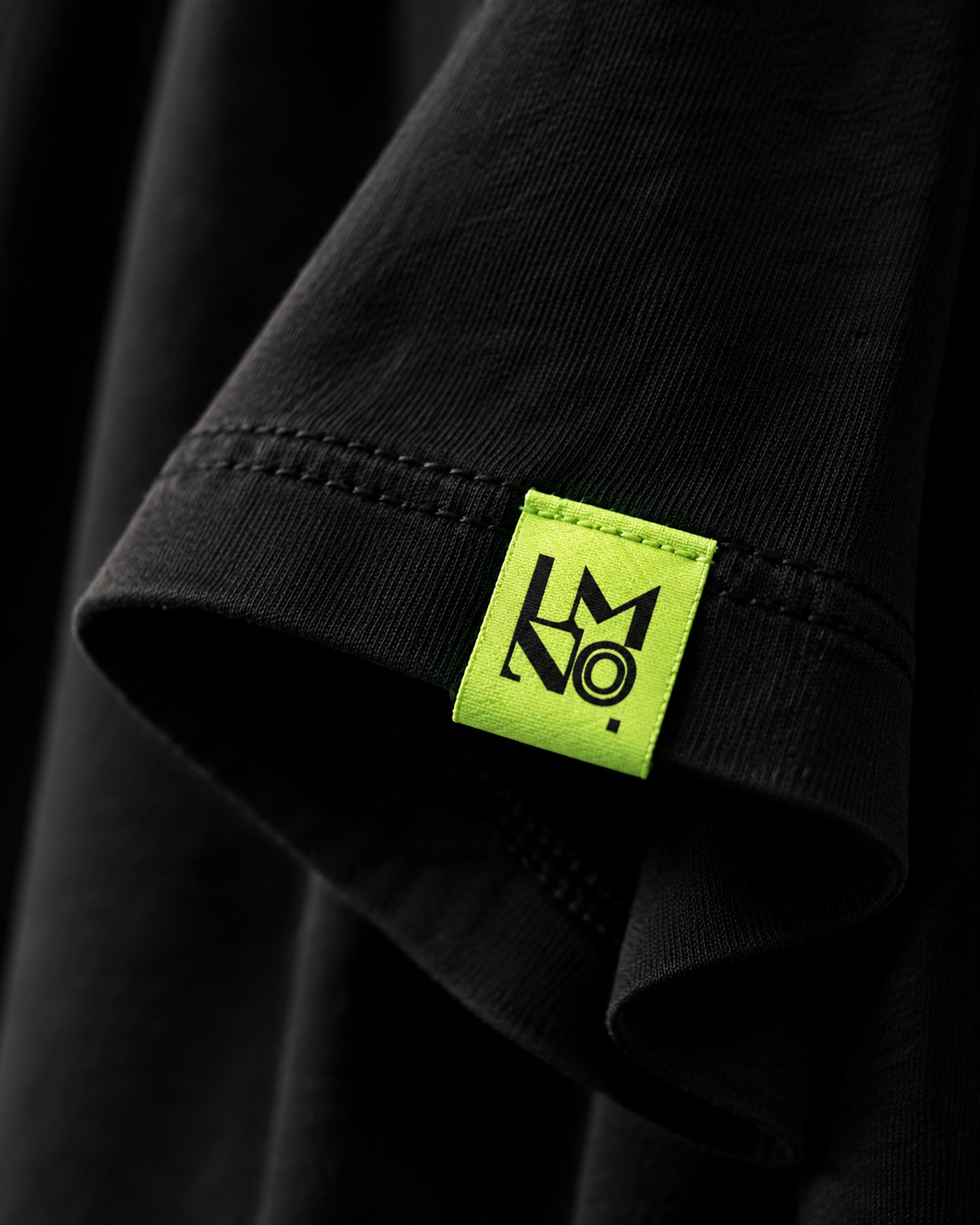 Close-up of LMNO brand label on Wild oversized cotton t-shirt